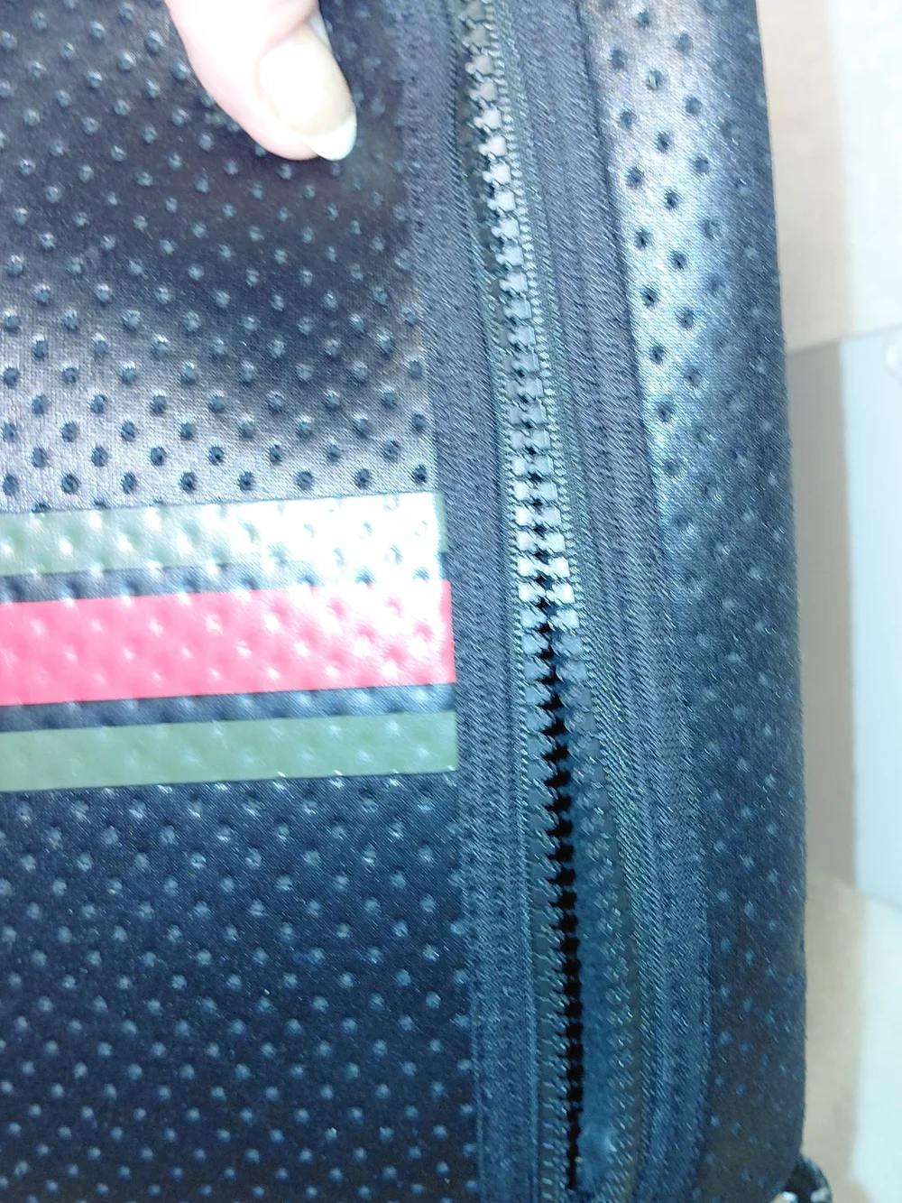 New perforated black leatherBlack Perforated Zip Pouch with Green and Red Stripe